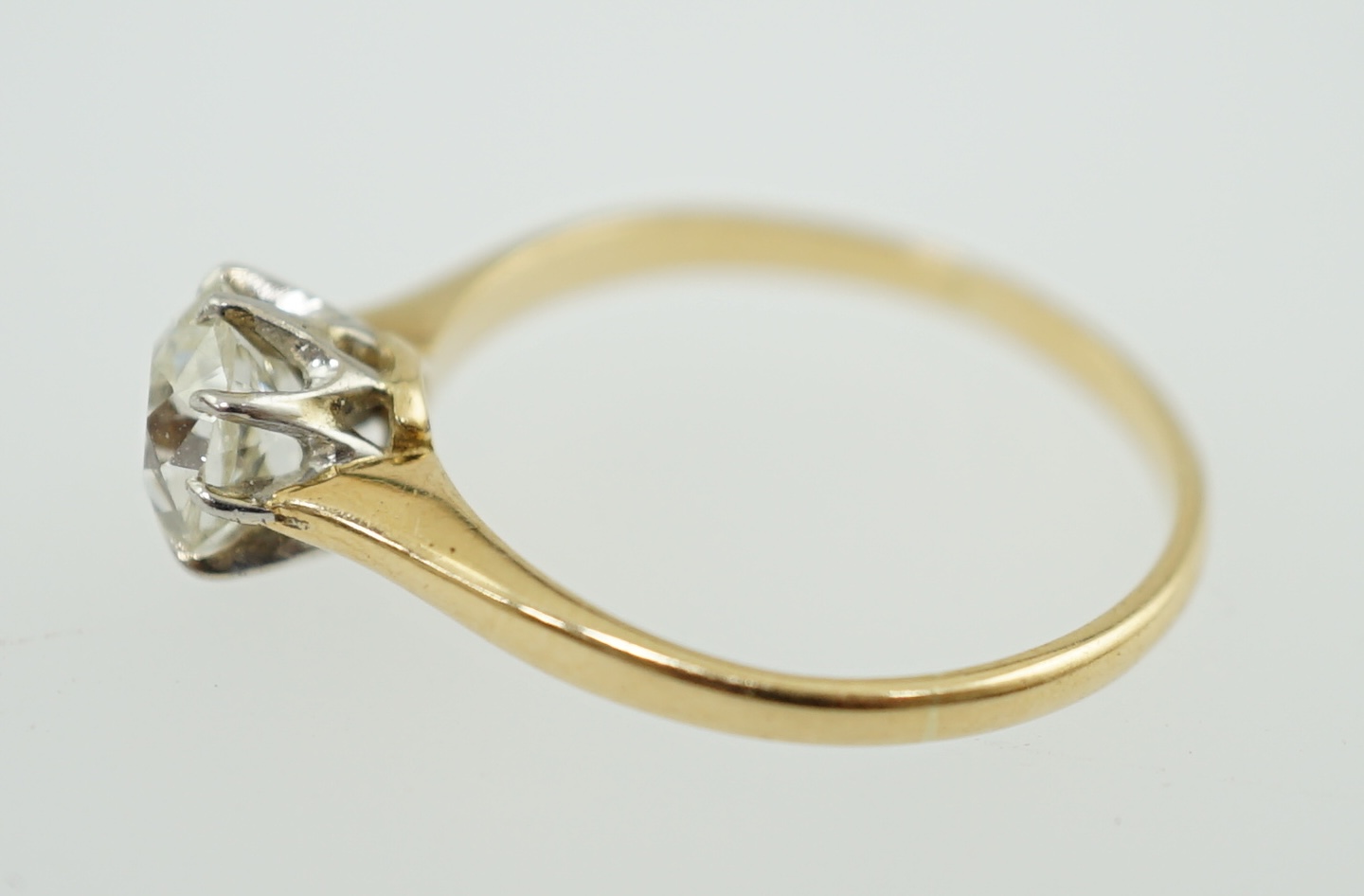 A gold and cushion cut solitaire diamond set ring